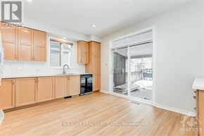 Ottawa apartment for rent - A kitchen with wooden cabinets and a black oven.