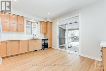 Ottawa apartment for rent - A kitchen with wooden cabinets and a black oven.