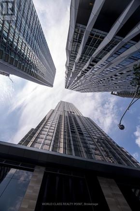 Toronto (Annex) condo for rent - The image shows a view of skyscrapers from a low angle.