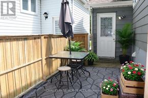 Caledon (Bolton North) apartment for rent - A patio with a table and chairs and a potted plant.