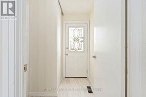 Caledon (Bolton North) apartment for rent - A white door with a glass window in the middle is the focal point of this image.
