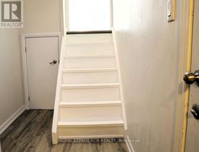 Caledon (Bolton North) apartment for rent - A white staircase with a door on the left and a door on the right.
