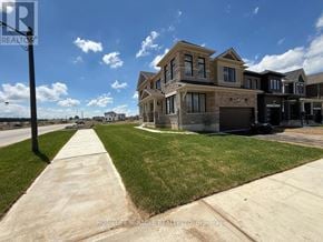 Brantford apartment for rent - A row of houses with a sidewalk in front.