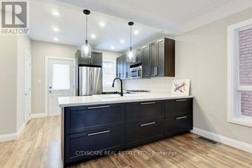 Hamilton (Gibson) apartment for rent - A kitchen with black cabinets and a white countertop.
