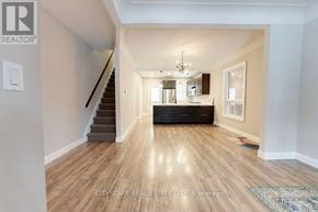 Hamilton (Gibson) apartment for rent - A spacious living room with hardwood floors and a staircase leading to the upper level.