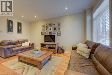 Stoney Creek townhouse for rent - A living room with a brown couch and a wooden coffee table.