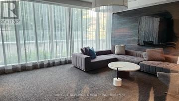 Toronto (Church-Yonge Corridor) condo for rent - A living room with a grey couch and a white coffee table.