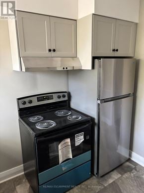 Niagara Falls (Downtown) multi-family for rent - A stainless steel refrigerator and stove in a kitchen.