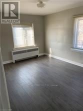 Niagara Falls (Downtown) multi-family for rent - A room with a window and a radiator on the wall.