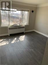 Niagara Falls (Downtown) multi-family for rent - A room with a window and a radiator on the floor.