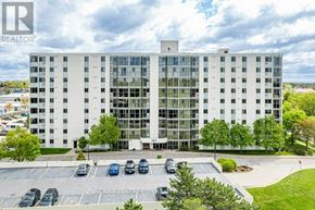London South (South O) condo for rent - A large white building with a parking lot in front of it.