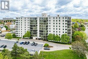 London South (South O) condo for rent - A large white building with a parking lot in front of it.