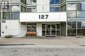 London South (South O) condo for rent - A building with the number 127 on it has a bench in front.