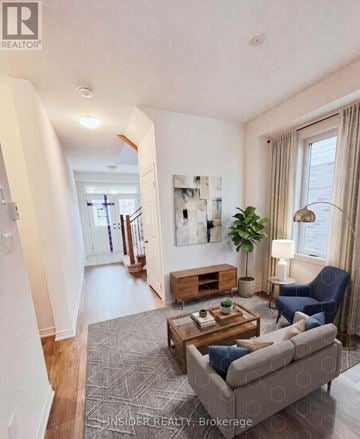 Centre Wellington (Fergus) apartment for rent - A living room with a grey couch, a wooden coffee table, and a painting on the wall.