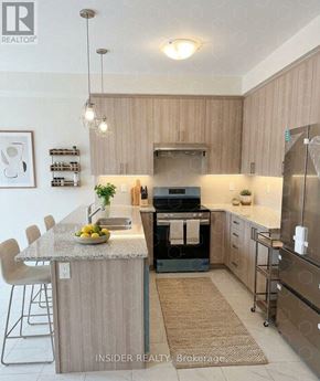 Centre Wellington (Fergus) apartment for rent - A modern kitchen with a granite countertop and stainless steel appliances.