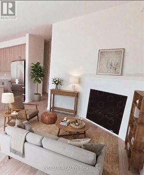 Centre Wellington (Fergus) apartment for rent - A living room with a grey couch, a wooden coffee table, a potted plant, a lamp, and a fireplace.