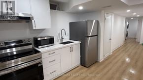 Markham (Middlefield) apartment for rent - A kitchen with white cabinets and stainless steel appliances.