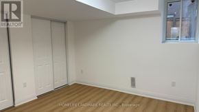 Markham (Middlefield) apartment for rent - A room with a white wall and a wooden floor.