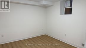 Markham (Middlefield) apartment for rent - A room with white walls and wooden flooring, with a window on the right wall.