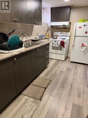 Brampton (Brampton South) apartment for rent - A kitchen with a white fridge and a white stove.