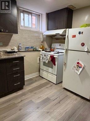 Brampton (Brampton South) apartment for rent - A kitchen with a white fridge and a white oven.
