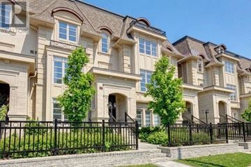 Oakville (Wo West) townhouse for rent - A row of houses with black fences in front.