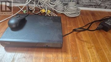 Niagara Falls (Downtown) apartment for rent - A black computer mouse is placed on a black box with a power cord plugged into an outlet.