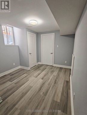 Cambridge apartment for rent - A room with wooden flooring and two white doors.