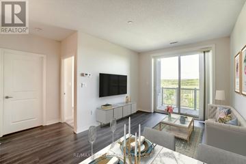 Milton (Sc Scott) condo for rent - A living room with a grey couch and a television on the wall.