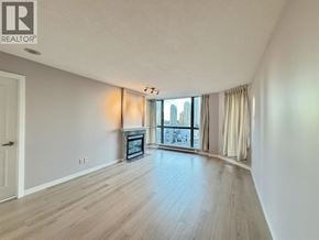 Burnaby apartment for rent - A spacious living room with a fireplace and a view of the city.