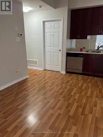 Brampton (Sandringham-Wellington) townhouse for rent - A kitchen with wooden floors and white walls.