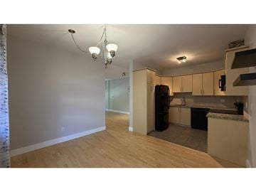 Surrey townhouse for rent - A kitchen with a refrigerator, cabinets, and a countertop.