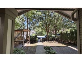 Surrey townhouse for rent - A view from a house looking out to a tree-lined driveway.