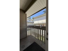 Surrey townhouse for rent - A balcony with a sliding door and a railing.