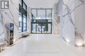 Toronto (Mimico) condo for rent - A hallway with marble walls and floors, and a glass door in the background.