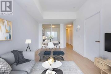 Toronto (Mimico) condo for rent - A living room with a grey couch and a wooden coffee table.