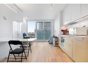 Surrey apartment for rent - A kitchen with a table and chairs in front of a window.