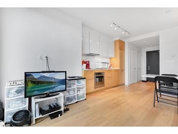 Surrey apartment for rent - A modern living room with a television and a chair.