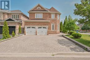 Brampton (Bramalea North Industrial) apartment for rent - A large house with a brick facade and a driveway in front.