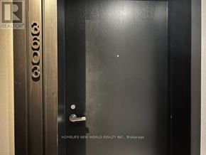 Toronto (Church-Yonge Corridor) condo for rent - A black door with a silver handle and a sign that says "HOMELIFE NEW WORLD REALTY INC. Brokerage".