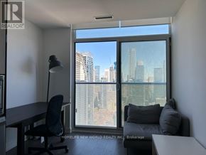 Toronto (Church-Yonge Corridor) condo for rent - A room with a desk and a chair in front of a window with a city view.