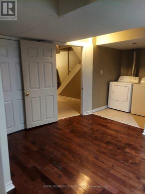 Brampton (Bram East) apartment for rent - A room with wood flooring and a white door.