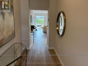 Kawartha Lakes (Bobcaygeon) townhouse for rent - A hallway with a glass table and a mirror on the wall.
