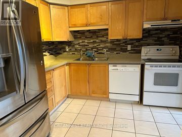 Mississauga (Meadowvale Village) apartment for rent - A kitchen with wooden cabinets and a stainless steel refrigerator.