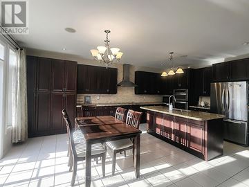 Vaughan (Patterson) apartment for rent - A kitchen with a table and chairs in the middle of the room.