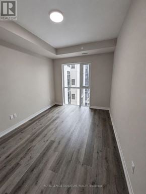 St. Catharines (E. Chester) condo for rent - A room with wooden flooring and a doorway leading to another room.
