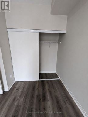 St. Catharines (E. Chester) condo for rent - A room with a white closet and wooden floors.