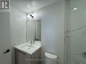 Vaughan (Vaughan Corporate Centre) condo for rent - A bathroom with a sink, mirror, and toilet.