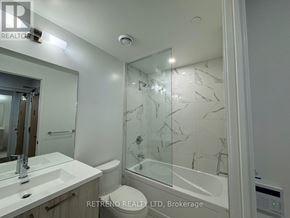 Vaughan (Vaughan Corporate Centre) condo for rent - A bathroom with a glass shower door and a white sink.