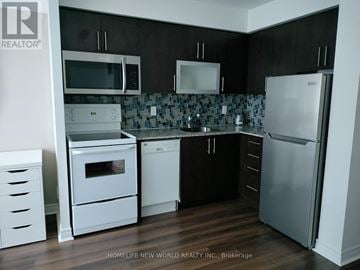 Toronto (Bendale) condo for rent - A kitchen with a white oven and black cabinets.